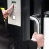 Man entering code in keypad to unlock security door